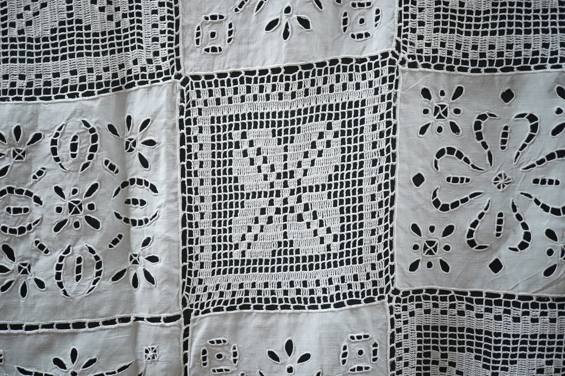 A fancy crochet and anglaise hand worked tablecloth, together with a collection of lawn and linen table linen, mats, etc. and various lengths of lace including a panel of Irish crochet, Irish crochet panel 142cm long x 5